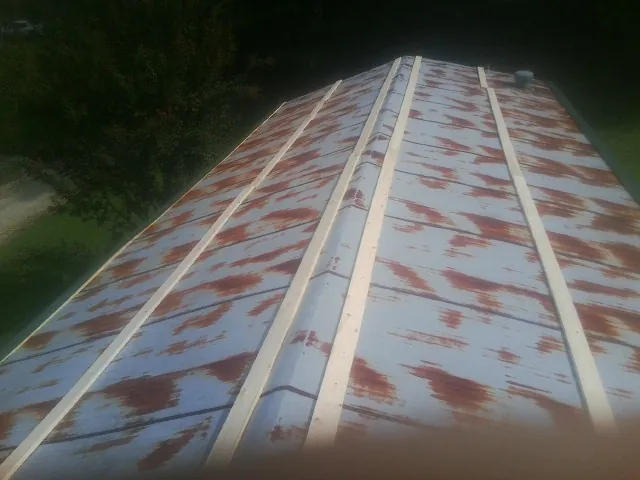 Rusted metal roof panels with new wood purlins before replacement — Storm Damage Roof Repair in Bonanza by Roofing Brothers