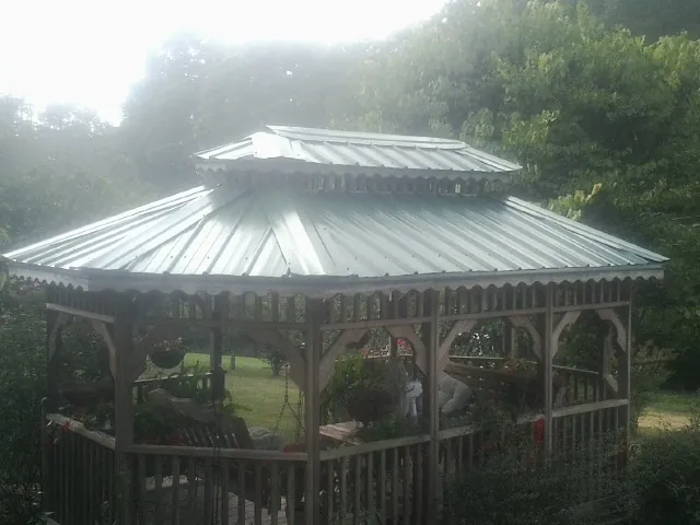 Two tier green metal roof on a garden gazebo in Bonanza